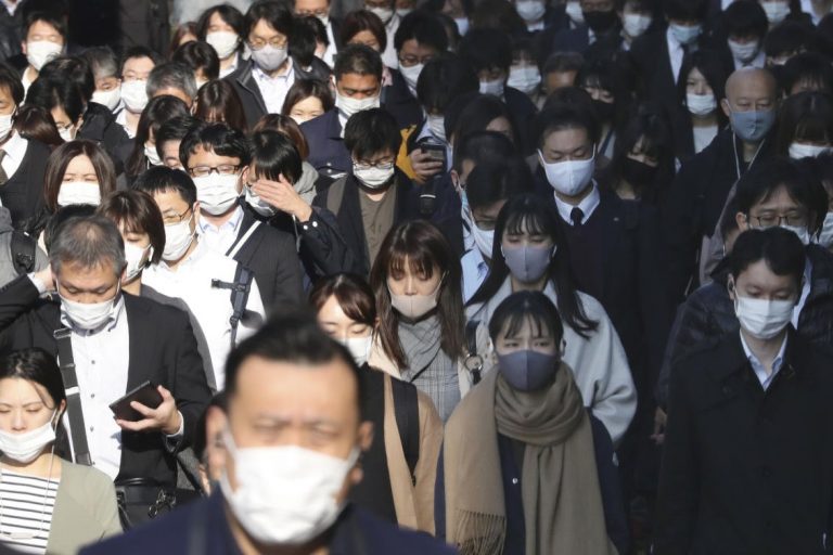 Japan’s capital raises coronavirus alert to highest as cases set record