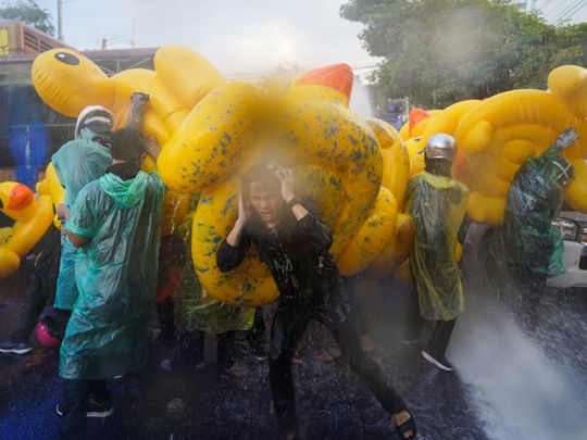 In pictures: Thai protesters use inflatable ducks against water cannons