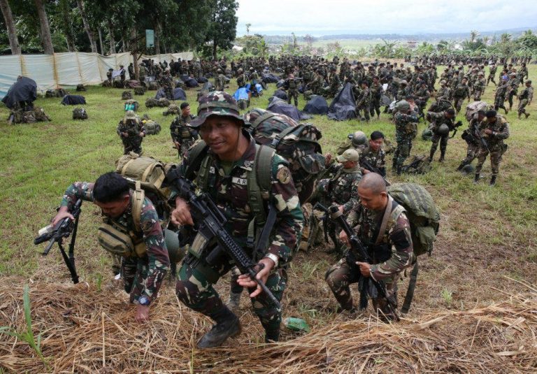 Militants open fire and burn police car in Philippine town