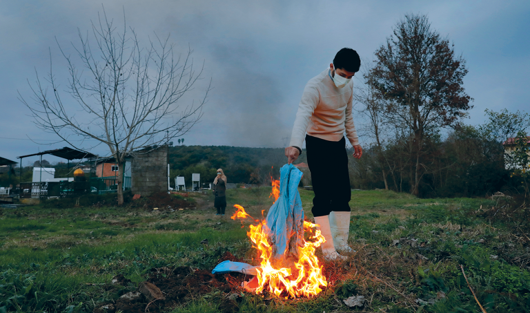 Far from the capital, Iran struggles to bury virus victims