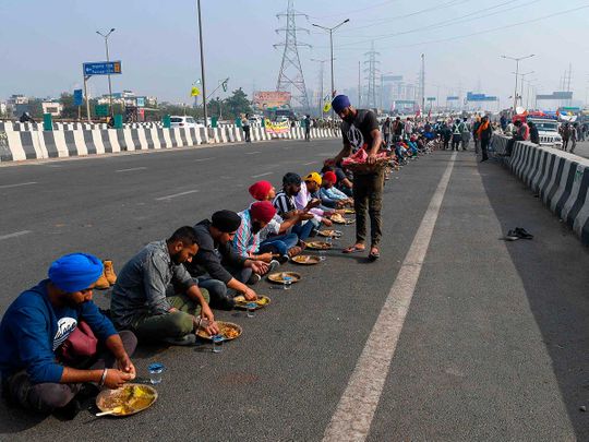 Hay beds and highway kitchens: Indian farmers dig in for reform protests