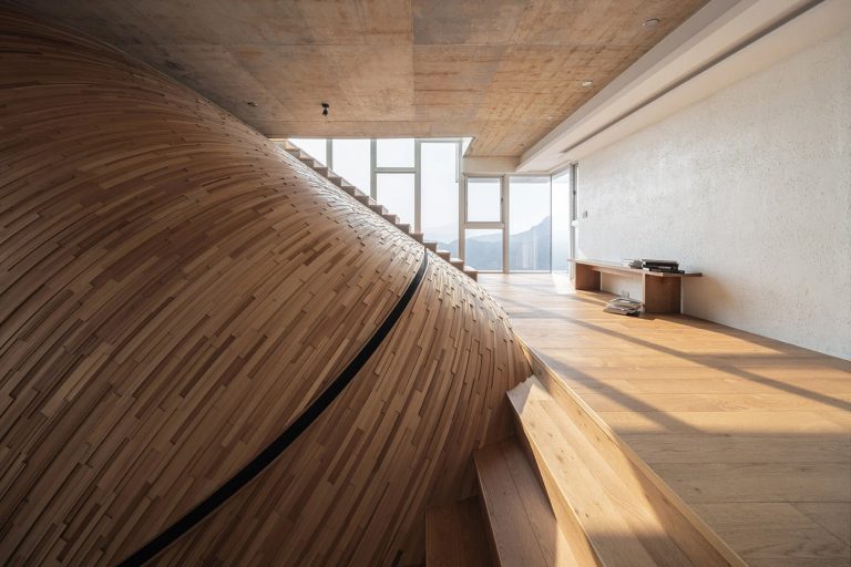 A Striking Curved Wall Swells Upward Across Three Stories of a Taipei Home by Yuan Architects