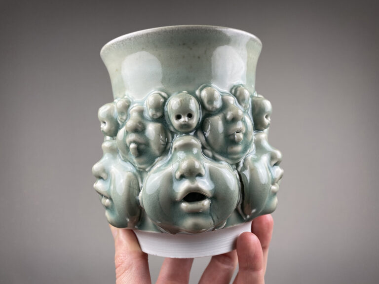 Faces and Fingers Glazed in Celadon Emerge from Surreal Vessels by Canopic Studio