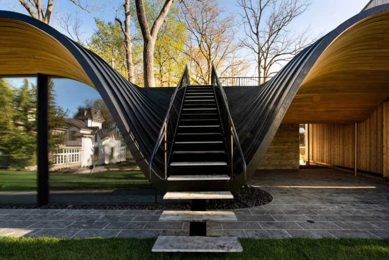 An Undulating Roof Made of Cedar and Steel Flows Out from a Pool House in Ontario