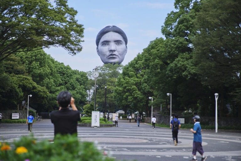 Massive Human Faces Loom Over Japanese Cities in Uncanny Balloon Works by Mé