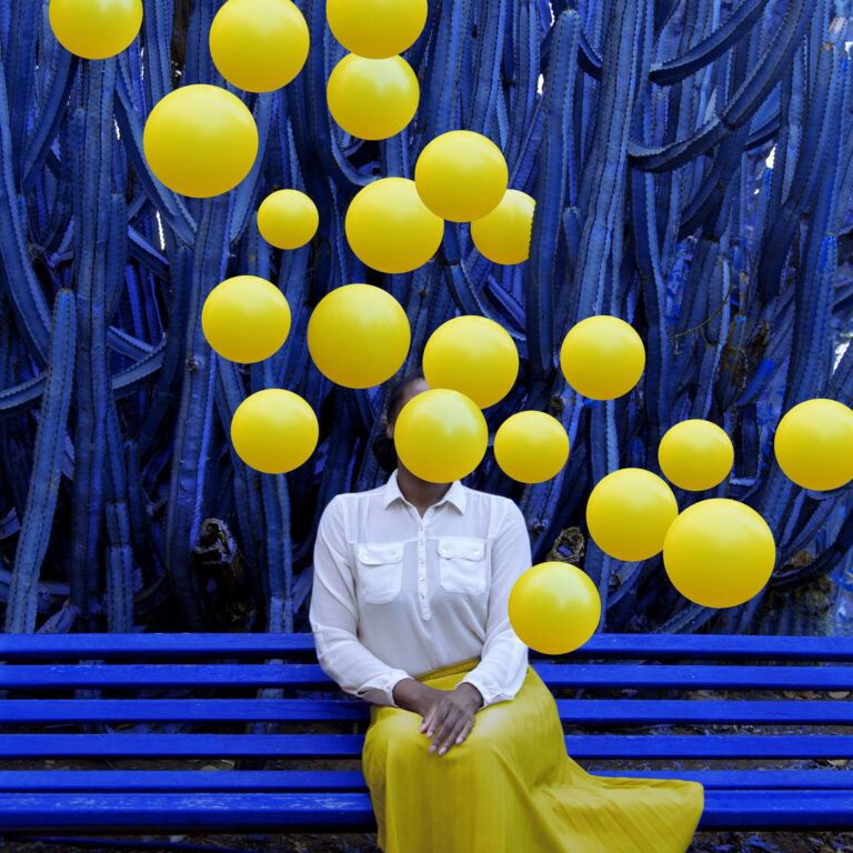 Clusters of Bright Balloons Envelop Photographer Fares Micue in Her Expressive Self-Portraits