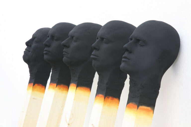 Nondescript Human Heads Appear Burned into Large-Scale Matches by Wolfgang Stiller