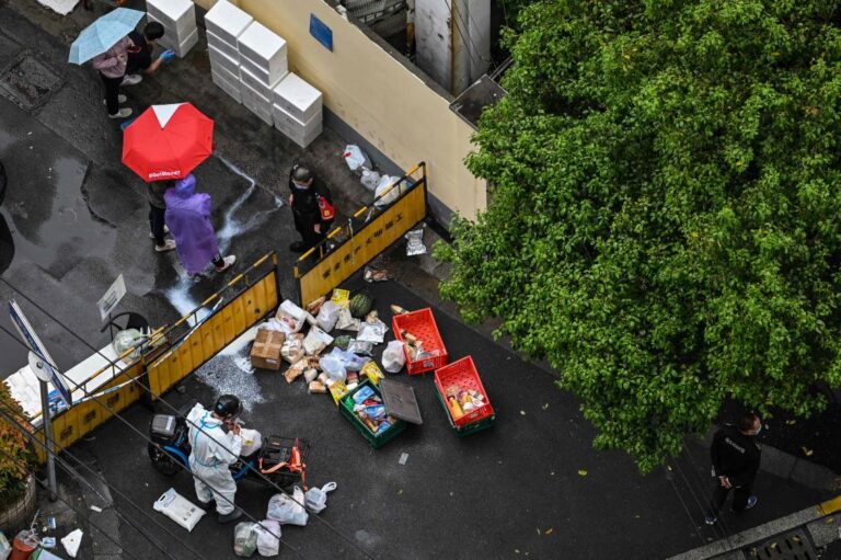 Shanghai fences off coronavirus-hit buildings, fueling fresh outcry