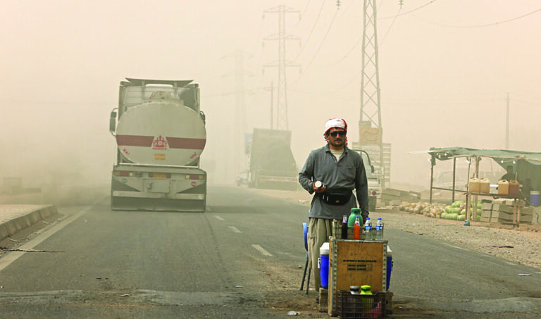 Weathering sandstorms, Iraqis grit teeth and battle on
