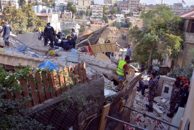 Rescuers search for trapped people in collapsed building in Jordan
